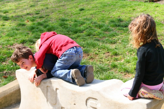 Kade on top of Ethan, with Jocelyn onlooking